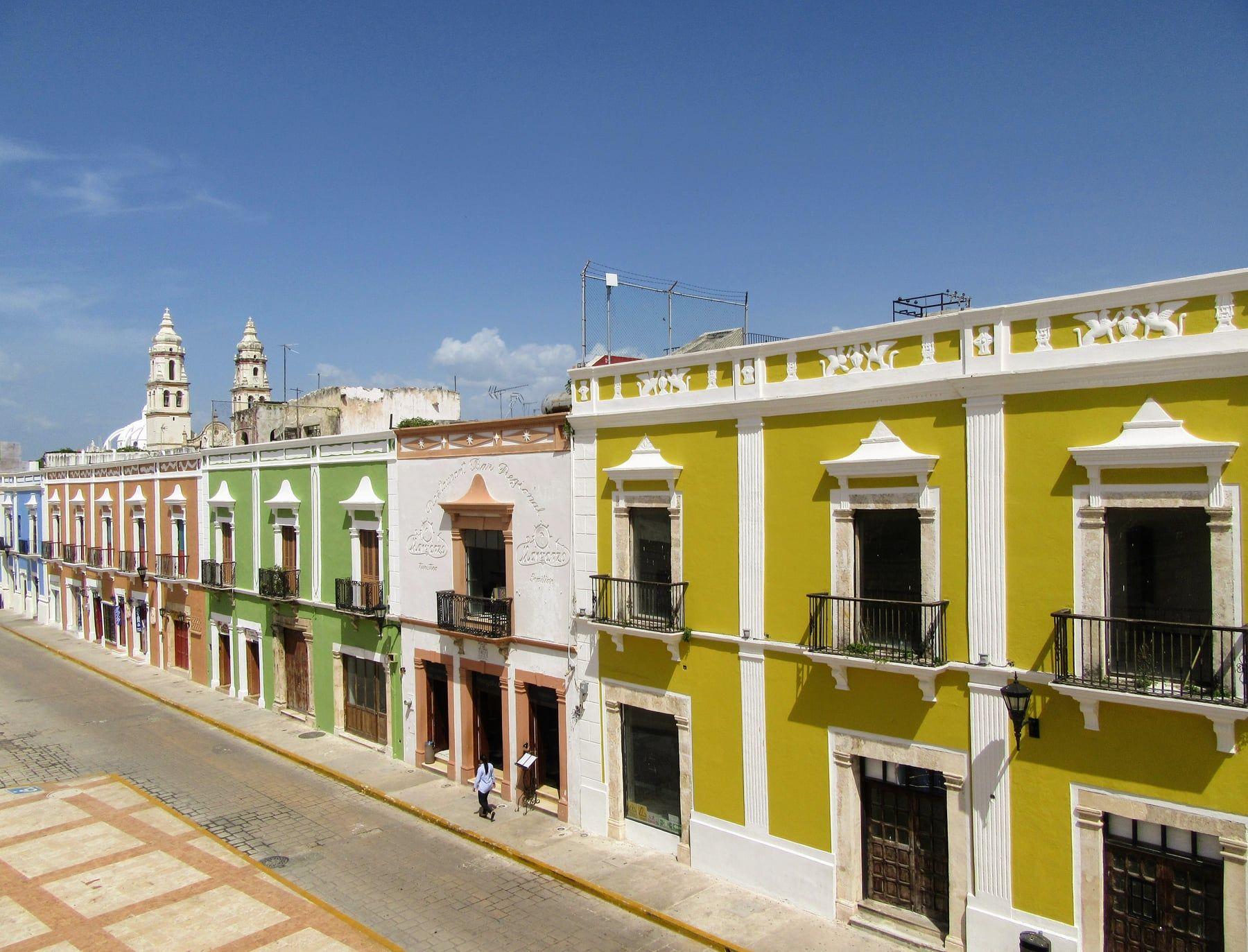 Historic buildings along a sunlit street in Mexico